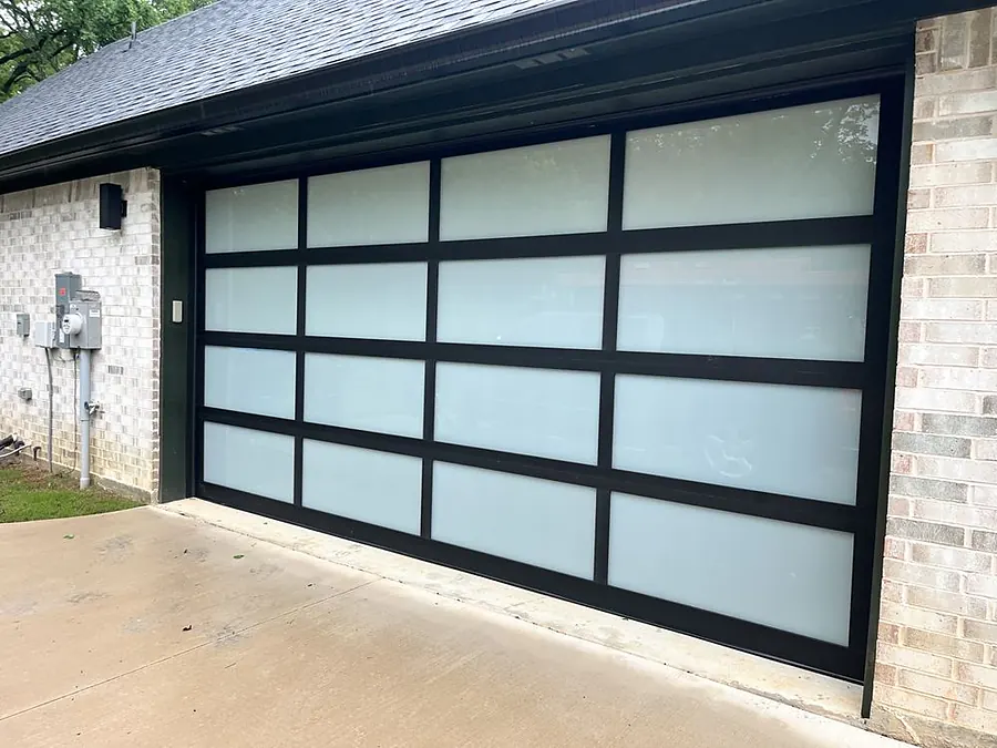 Black aluminum full-view garage door with frosted glass panels