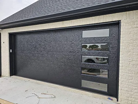 Modern black garage door with a stacked row of five horizontal windows