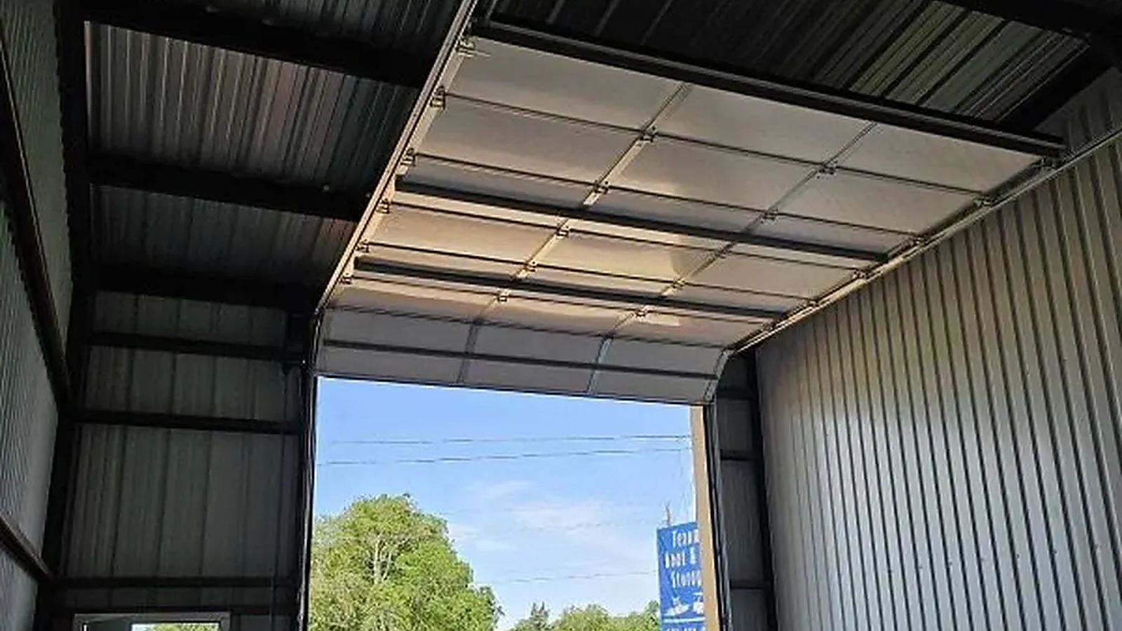 Garage door cable and track hardware visible from inside a metal garage